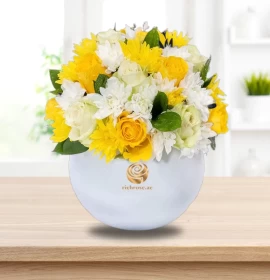 White and yellow flowers in bowl