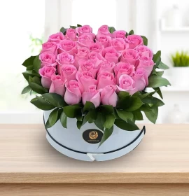 pink roses in white round box